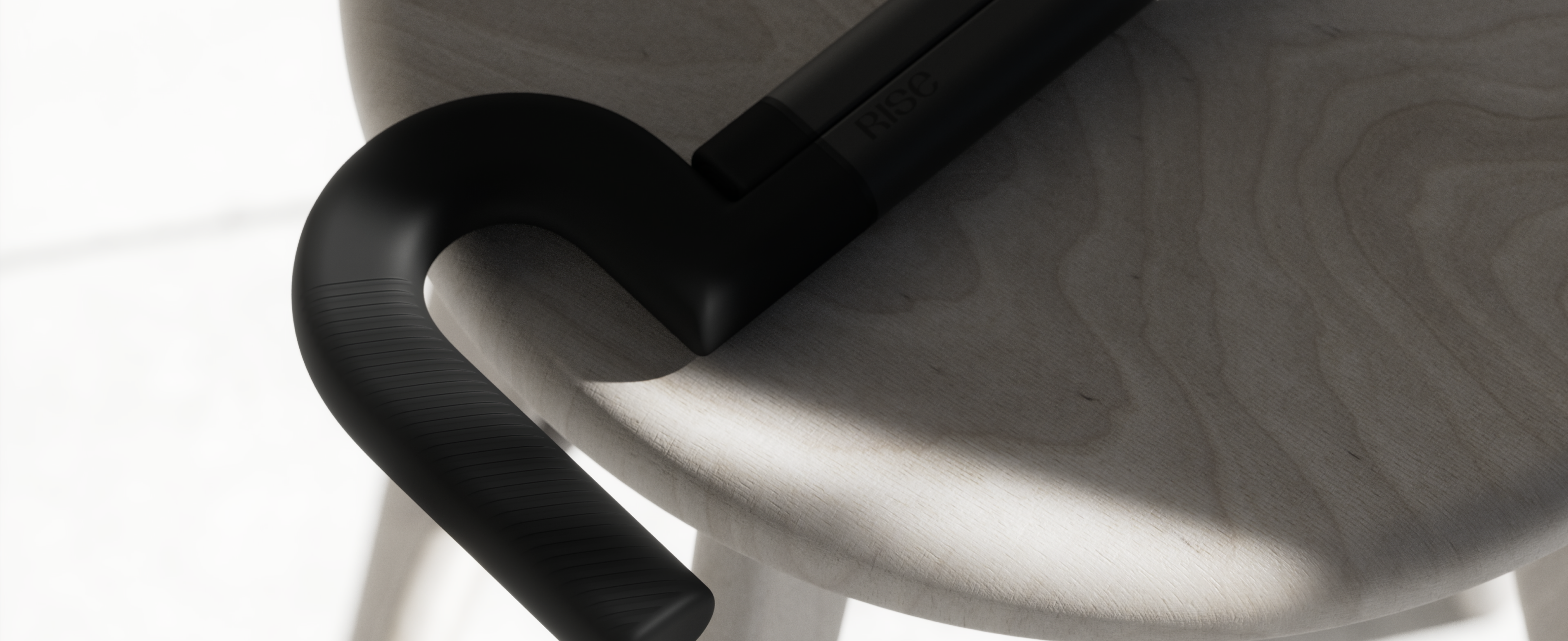The Rise cane handle resting on the curved back of a wooden chair
