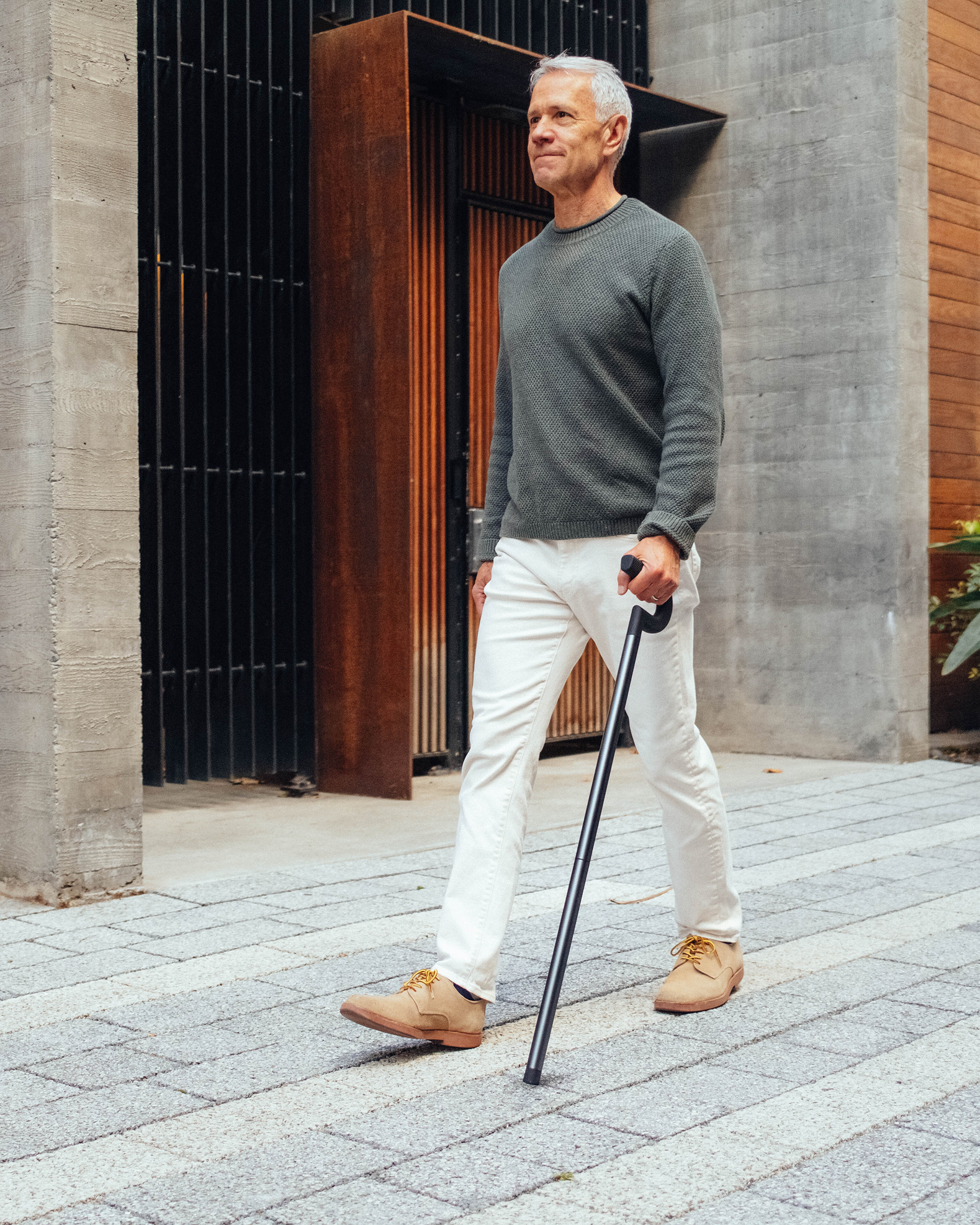 A person walking with the Rise cane
