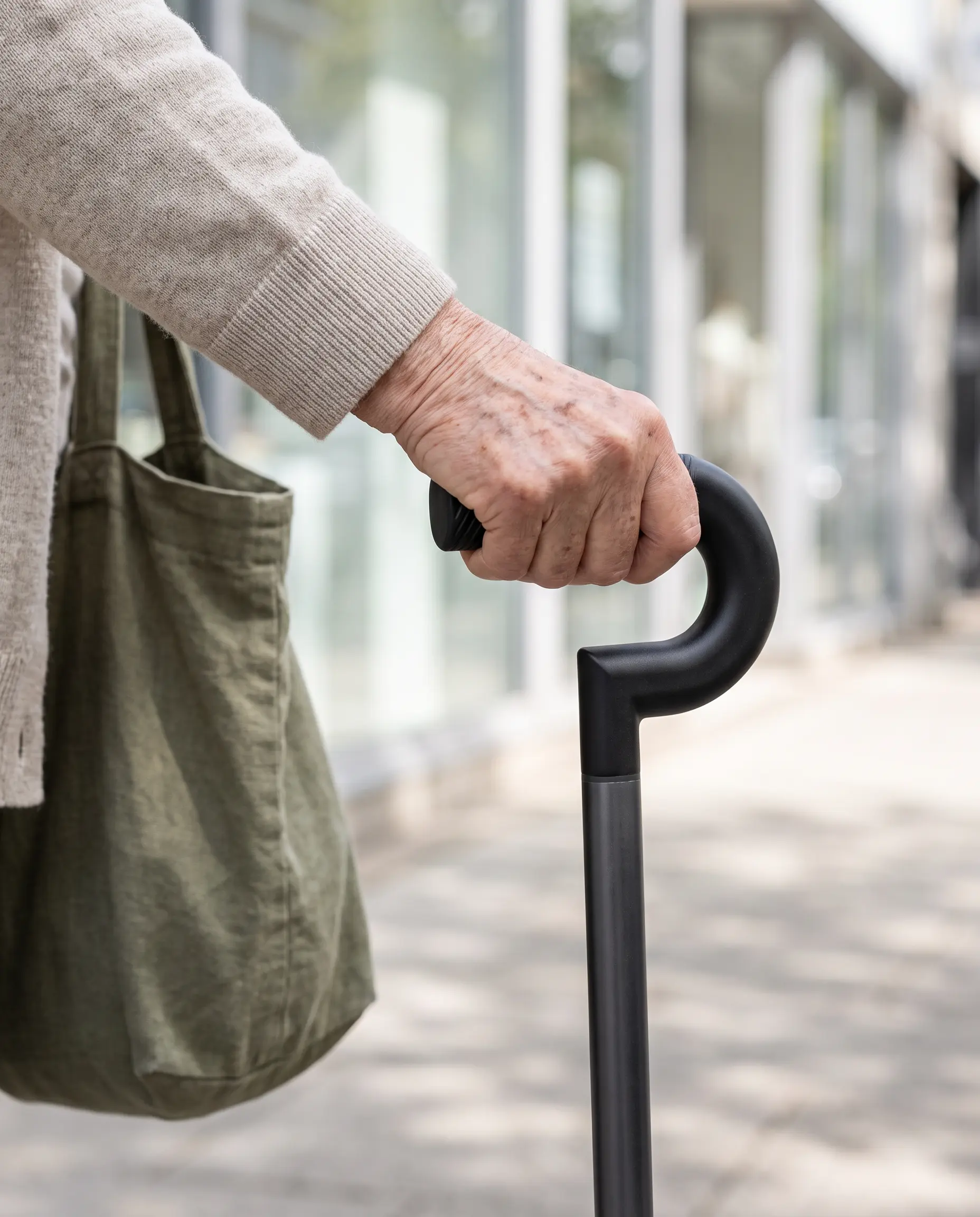 A woman in a trench coat walking with the Rise cane